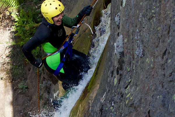 Person abseiling in a waterfall