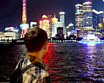 Look across the water at the lit-up buildings