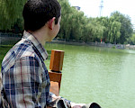 Author sitting looking out over a river