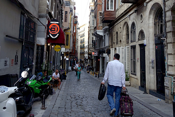 A narrow cobbled street with buildings on each side