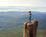 Photo of man on a pinnacle taking a photo