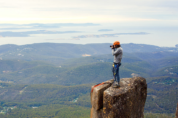 Photo of man on a pinnacle taking a photo